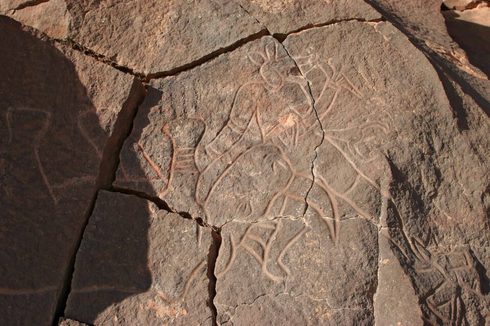 A man hunting a rhinoceros engraved on the rock at In Habeter (Uadi Mathendush, Akakus, Libya)